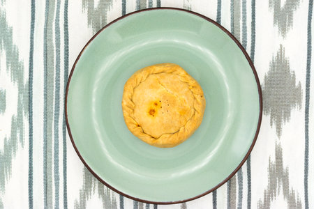 Top view of a panada, traditional Majorcan Easter dish. Disposed on a fabric of "roba de llengos".の写真素材