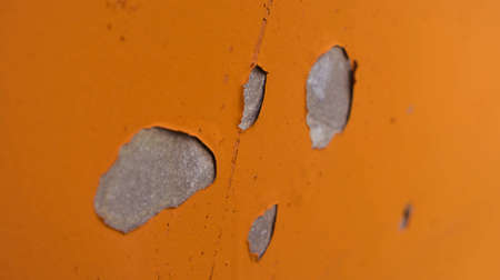 part of the metal gray rusting gate with the paint damaged yellow, brown and orange tones spotsの写真素材