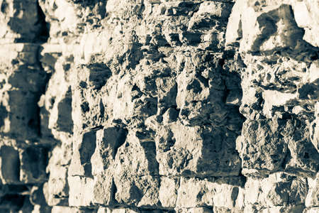 stone ruined wall collapses in parts, autumn yellow maple leaf hangs on the rocks on the rocks,の写真素材