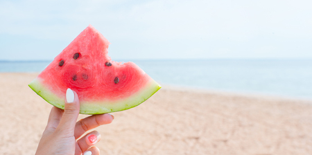 Watermelon on a background of a sandy beach and the sea.の写真素材