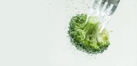 Pieces of appetizing broccoli in clear water.の写真素材