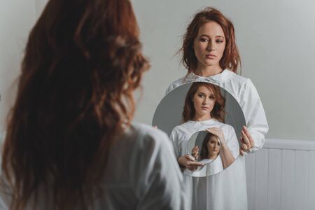 Studio portrait of two red-haired twin girls.の写真素材