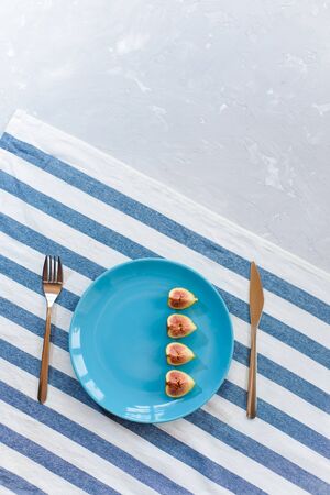 Fresh, ripe figs on a blue plate.の写真素材