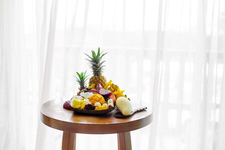 Juicy ripe tropical Thai fruits on a wooden dish.の写真素材