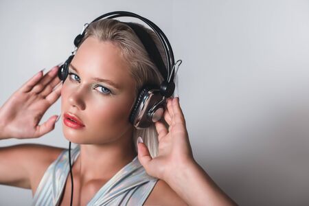Attractive young blonde listening to music on headphones.の写真素材