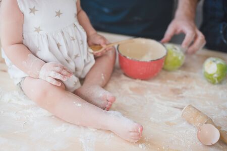 Cropped photo dad with his little daughter baking together.の写真素材