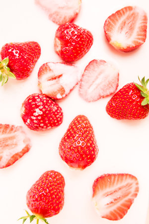 A lot of ripe juicy strawberries in milk, cream or yogurt.の写真素材