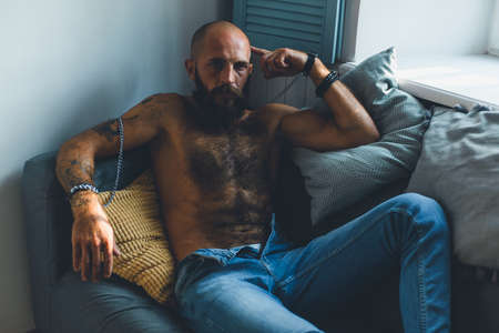 Portrait of a brutal bearded man with a naked torso.の写真素材