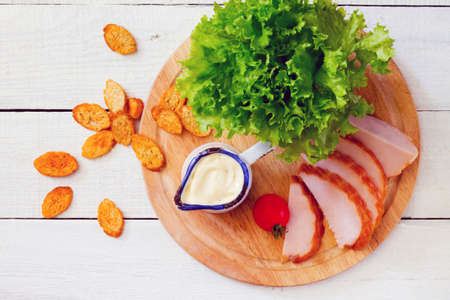 Caesar salad dressing and products included in the salad lettuce, tomato, croutons, smoked chickenの写真素材