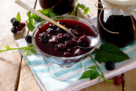 Blackberries, canned in juice cans on a wooden table