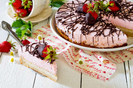 Cake ice cream with strawberries on a wooden table
