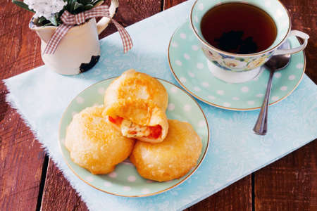 Fried donuts cakes with tomato and cheese, nga wooden tableの写真素材