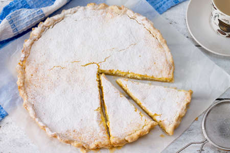 Cheesecake with cream cheese, puff pastry on a white wooden tableの写真素材