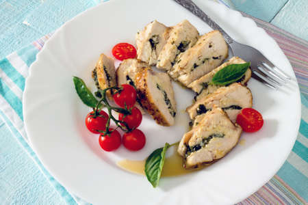 Chicken fillet baked with parsley on a wooden tableの写真素材