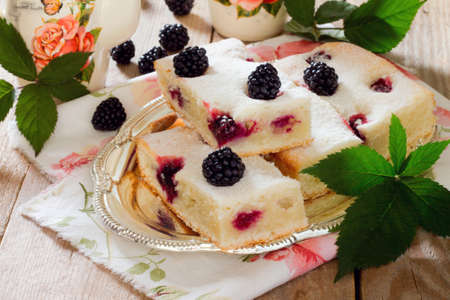 Cake cake with fresh blackberries on a wooden tableの写真素材