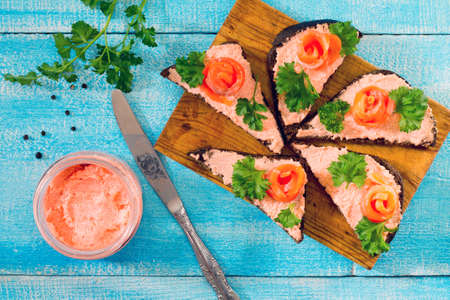 Sandwiches with red fish (salmon) in a rustic styleの写真素材