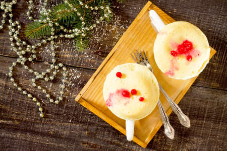 Quick food cake in a mug on a table in the New Year's Eve, the view from the top.