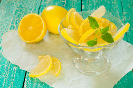 Marmalade lemon slices on a wooden tableの写真素材
