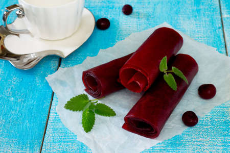 Traditional oriental sweets - candy cherry on a wooden table, selective focus.の写真素材