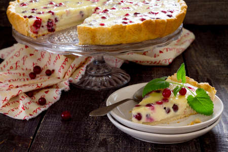 Cakes, pies, shortbread dough with fresh cranberries flood in a rustic style.の写真素材