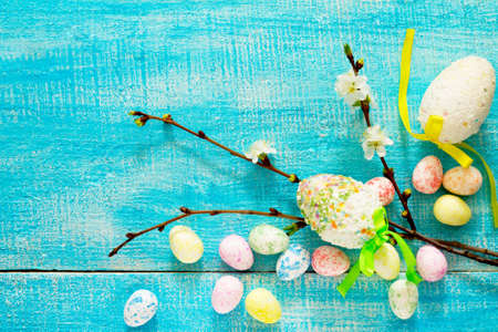 Colorful Easter eggs and cherry branch, place for text