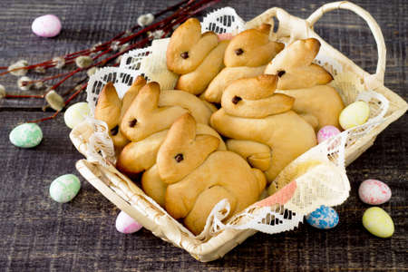 Baking Easter bunny in a wicker basket on a dark background
