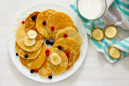 Banana pancakes with honey and fresh berries currantの写真素材