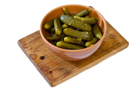 Pickled cucumbers gherkins in ceramic cup on a white backgroundの写真素材