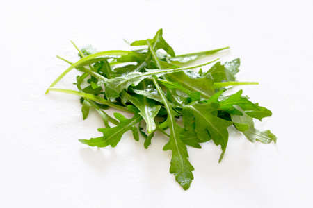Arugula leaves on white background, selective focus.の写真素材