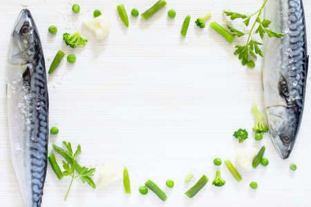 Fresh tasty vegetables and raw fish for cooking on a wooden background, room for text. Diet or vegetarian food concept.の写真素材