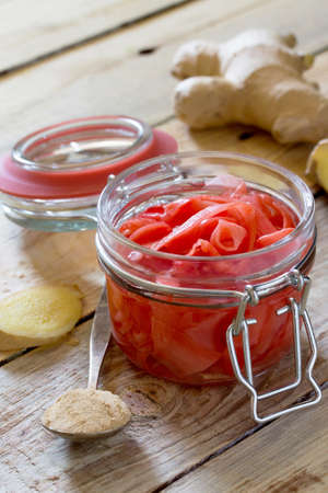 Ginger root and slices of pickled ginger on a wooden tableの写真素材