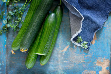 Fresh organic cucumbers on a wooden table, top view. Space for your text.の写真素材