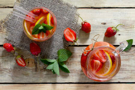 Tradition Summer mojito drink with lemon and mint with copy space on a wooden rustic table. Top view.の写真素材