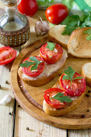 Italian tomato bruschetta with sun dried tomatoes, herbs and butter grilled or fried crispy ciabatta breadの写真素材