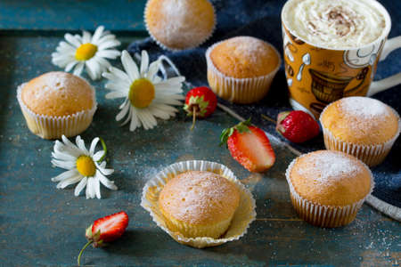 Delicious cake with strawberries on a vintage wooden background