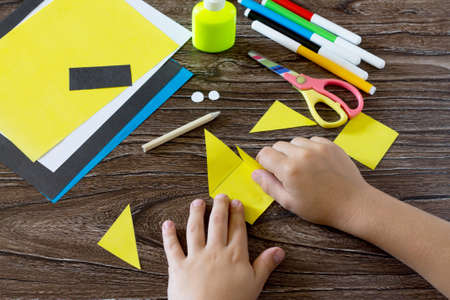 The child makes a book with a bookmark mignon. The child bonded items paper products. Glue, paper,...