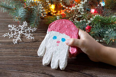 Child paints acrylic paints Christmas toy from the salty test frost grandfather. Children's art project, a craft for children.の写真素材