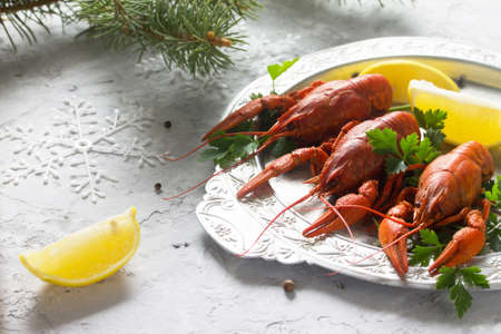 Boiled crawfish, lemon and parsley on a concrete background. Appetizer for Christmas or New Year's table. Food background. The concept of healthy eating.の写真素材