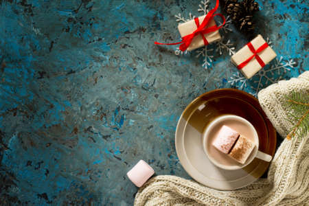 Winter. A cup of hot chocolate with marshmallows and christmas presents. Top view, copy space.の写真素材