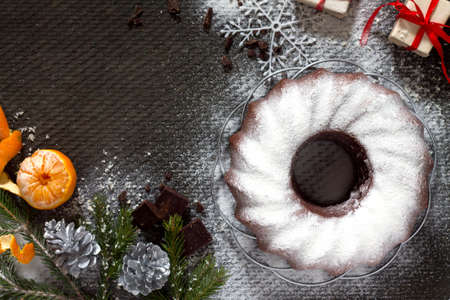 Traditional homemade chocolate cake Christmas holiday dessert in the new year tree decoration on old concrete background. Copy space.の写真素材