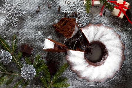 Traditional homemade chocolate cake Christmas holiday dessert in the new year tree decoration on old concrete background. Copy space.の写真素材
