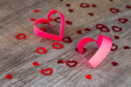 Two paper hearts Valentine, wooden background with heart.
