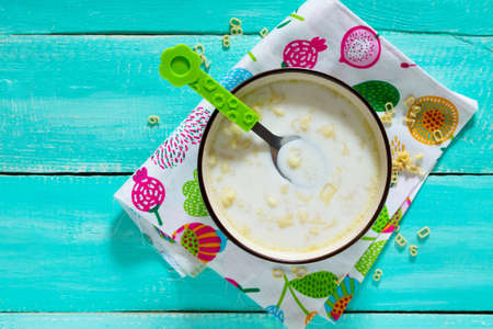 Dinner or breakfast children - milk soup with pasta in the form of numbers and letters. Food for children. Top view.の写真素材