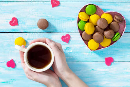Valentine's Day or birthday gifts Macarons Cake heart and cup of coffee on a blue wooden table. Declaration of love. Top view.の写真素材
