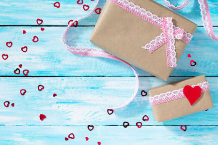Valentine's Day or birthday gifts with a heart on a blue wooden table. Declaration of love. Top view.の写真素材