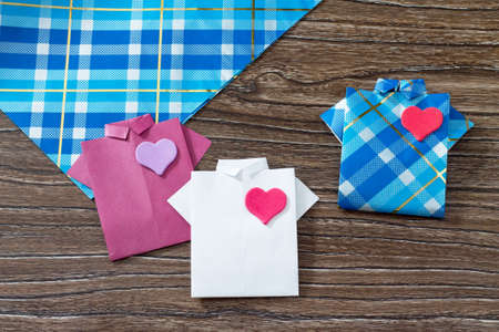 Gift for Father's Day background, copy space. Gift shirt origami paper heart. Made with his own hands. Children's art project, a craft for children.の写真素材