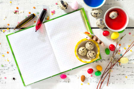 Cooking recipe background for Easter celebration: quail eggs are and paint on a white background. Top view, copy space. Food background.の写真素材