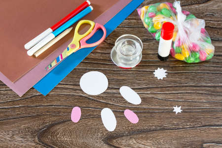 The child cuts out details Easter greeting card packaging paper Easter bunny candy. Handmade. Children's Art Project, needlework, crafts for children.の写真素材