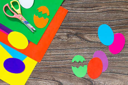 Easter frame craft. Easter greeting paper Easter eggs on a wooden table. Copy space. Children's Art...