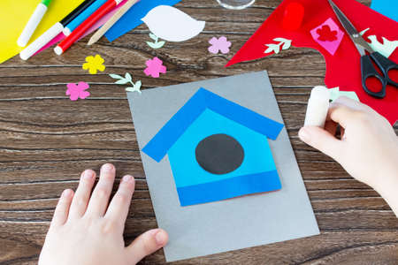 Child sticks paper details. The child create a spring greeting card paper. Made by hand. Craft for...